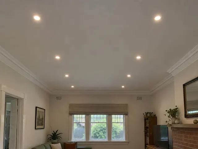 Living room ceiling with recessed downlights, beige walls and fireplace in Freshwater